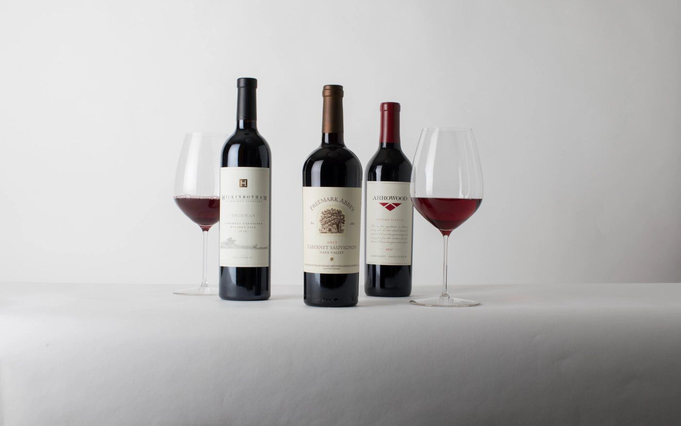 Three wine bottles with glasses