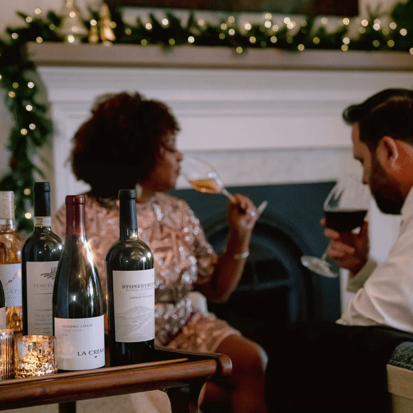 Man and women enjoying wine during the holidays