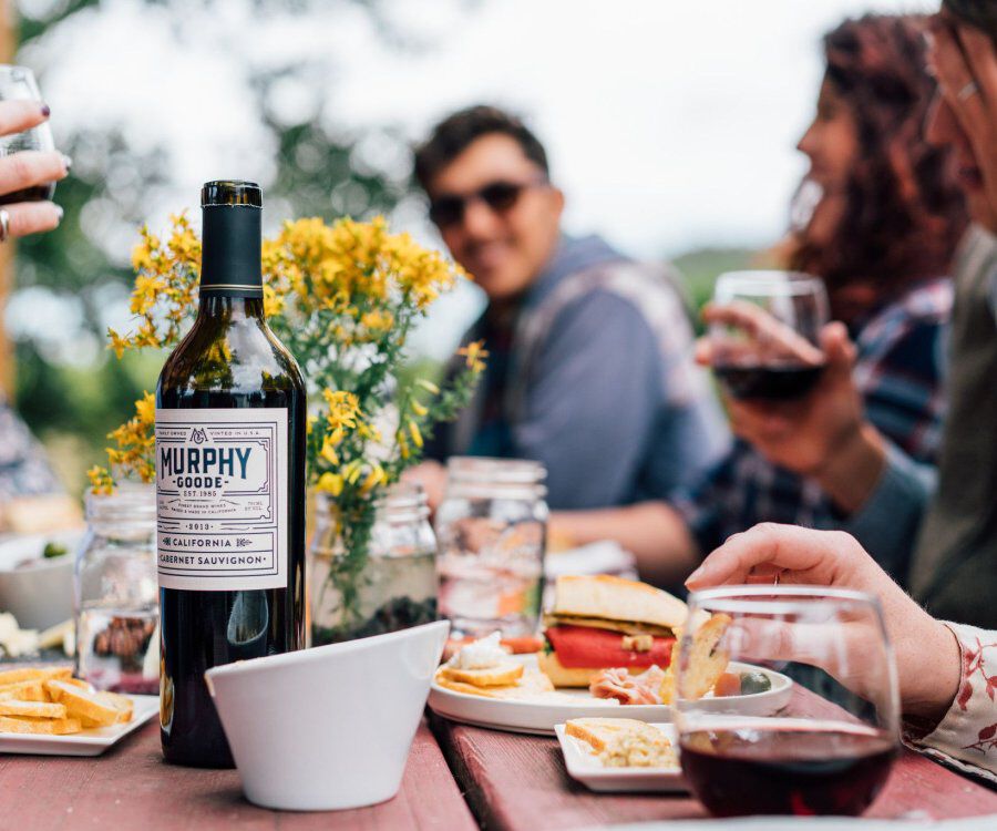 People enjoying Murphy Goode wine while eating cheese