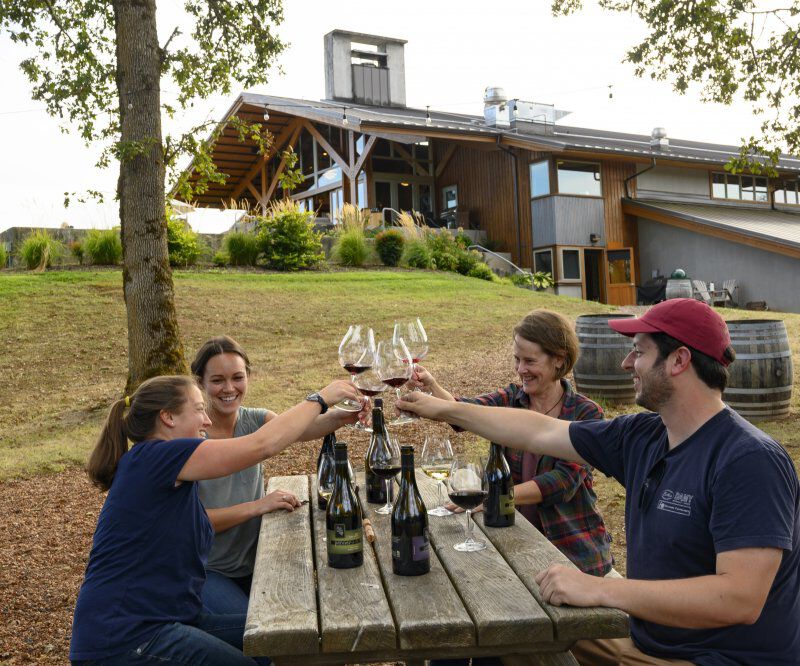 Guests at Penner-Ash Cheersing with wine glasses.